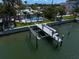 A waterfront property features a private dock, lift, and refreshing swimming pool at 202 Howard Dr, Belleair Beach, FL 33786