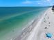 Picturesque beach featuring calm surf, clear water, and scattered beachgoers enjoying the sunshine at 202 Howard Dr, Belleair Beach, FL 33786