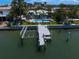 A waterfront home boasts a private dock and lift, plus a pool at 202 Howard Dr, Belleair Beach, FL 33786