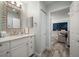 Bathroom featuring a decorative mirror over the sink and tiled floors, as well as access to the dining room at 202 Howard Dr, Belleair Beach, FL 33786