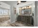 Bathroom showcasing a wood vanity with dual sinks and a walk-in shower with glass door at 202 Howard Dr, Belleair Beach, FL 33786