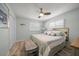 Bright bedroom showcasing wood floors, a ceiling fan, plantation shutters and light blue accents at 202 Howard Dr, Belleair Beach, FL 33786