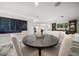 Open dining area with wood-look tile floors, a round table, and decorative chalkboard accent wall at 202 Howard Dr, Belleair Beach, FL 33786