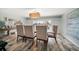 Tasteful dining room with stylish chairs, wood floors and a view of the water at 202 Howard Dr, Belleair Beach, FL 33786