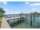 Dock with boat lift in a scenic waterfront neighborhood at 202 Howard Dr, Belleair Beach, FL 33786