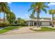 Charming single-story home with mature landscaping and a circular driveway at 202 Howard Dr, Belleair Beach, FL 33786