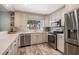 Modern kitchen with stainless steel appliances, white cabinets, and elegant countertop space at 202 Howard Dr, Belleair Beach, FL 33786