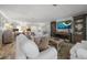 Light-filled living room boasts stylish furnishings, hardwood floors, and an inviting atmosphere at 202 Howard Dr, Belleair Beach, FL 33786