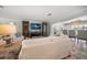 Comfortable living room featuring built-in shelving, sofas and a chandelier over the dining area at 202 Howard Dr, Belleair Beach, FL 33786