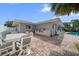 Back patio featuring an outdoor kitchen, table, chairs, and access to the pool at 202 Howard Dr, Belleair Beach, FL 33786