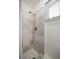 Bathroom shower features elegant marble tile and a modern shower head at 202 Howard Dr, Belleair Beach, FL 33786