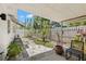 Backyard patio area with a mix of stone pavers, lush greenery, and a covered seating space at 204 Mindy Dr, Largo, FL 33771