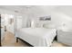Bright bedroom with white walls, light wood floors, and an ensuite bathroom at 204 Mindy Dr, Largo, FL 33771