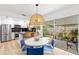 Cozy dining area featuring stylish pendant lighting, adjacent to a modern kitchen and outdoor patio at 204 Mindy Dr, Largo, FL 33771