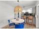 Open dining area with views of the kitchen and outdoor space, enhanced by a stylish light fixture at 204 Mindy Dr, Largo, FL 33771
