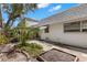 View of backyard with side view of house and a garden bed at 204 Mindy Dr, Largo, FL 33771