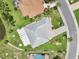 An aerial view showcasing the property's layout and landscaping in a well-maintained neighborhood at 2306 Emerald Lake Dr, Sun City Center, FL 33573