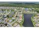 An aerial view of a lakeside community and multiple ponds surrounded by lush greenery at 2306 Emerald Lake Dr, Sun City Center, FL 33573
