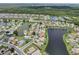 An aerial view pinpoints this lakeside community and ponds surrounded by lush greenery at 2306 Emerald Lake Dr, Sun City Center, FL 33573