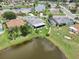 Aerial view of a neighborhood with mature trees, backyard pond and screened in lanai at 2306 Emerald Lake Dr, Sun City Center, FL 33573
