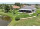 A charming screened-in porch overlooks the lush backyard with a scenic pond view at 2306 Emerald Lake Dr, Sun City Center, FL 33573