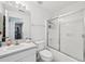 Clean bathroom featuring a shower with sliding glass doors, vanity, and toilet at 2306 Emerald Lake Dr, Sun City Center, FL 33573