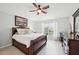 Bright bedroom with light hardwood floors, a ceiling fan, and stylish furniture at 2306 Emerald Lake Dr, Sun City Center, FL 33573