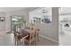 Cozy dining area with a view to the kitchen and outdoor patio through sliding glass doors at 2306 Emerald Lake Dr, Sun City Center, FL 33573