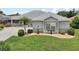 Charming single-story home with a well-maintained yard and beautiful landscaping at 2306 Emerald Lake Dr, Sun City Center, FL 33573