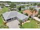 Stunning home showcasing a beautiful gray roof, landscaped yard and charming curb appeal at 2306 Emerald Lake Dr, Sun City Center, FL 33573