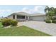 Charming single-story home with a two-car garage and manicured landscaping at 2306 Emerald Lake Dr, Sun City Center, FL 33573