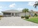 Charming single-story home with a well-maintained paver driveway, mature landscaping, and welcoming entrance at 2306 Emerald Lake Dr, Sun City Center, FL 33573