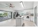 Bright, modern kitchen with a central island, stainless steel appliances, and sliding doors to the patio at 2306 Emerald Lake Dr, Sun City Center, FL 33573