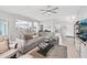 A large living room features fan, comfortable sectional sofa and ample natural light at 2306 Emerald Lake Dr, Sun City Center, FL 33573