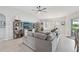 Comfortable living room area with fan, shelving, entertainment center and natural light at 2306 Emerald Lake Dr, Sun City Center, FL 33573