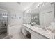 Bright main bathroom featuring a large tub, walk-in shower, dual sinks and plenty of vanity space at 2306 Emerald Lake Dr, Sun City Center, FL 33573