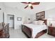 Bright main bedroom featuring light walls, wood dresser, and ensuite access at 2306 Emerald Lake Dr, Sun City Center, FL 33573