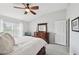 Bright main bedroom featuring gray walls, wood dresser with mirror, and ensuite access at 2306 Emerald Lake Dr, Sun City Center, FL 33573