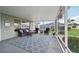 Cozy screened patio with comfortable seating and patterned rug, perfect for outdoor relaxation at 2306 Emerald Lake Dr, Sun City Center, FL 33573