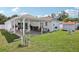 Covered patio with seating, great lawn and a garden shed at 2650 60Th N Ave, St Petersburg, FL 33714
