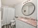 Bathroom with modern vanity, round mirror, and shower at 2650 60Th N Ave, St Petersburg, FL 33714