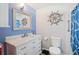 Bathroom with modern vanity, tile flooring, and shower with blue accents at 2650 60Th N Ave, St Petersburg, FL 33714