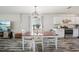 Dining room with white accents, laminate flooring, and a view of kitchen and living area at 2650 60Th N Ave, St Petersburg, FL 33714