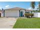 Charming single-story home with a well-maintained lawn and a vibrant blue front door at 2650 60Th N Ave, St Petersburg, FL 33714