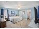 Light blue main bedroom with ceiling fan, carpet flooring, and ensuite bath access at 2650 60Th N Ave, St Petersburg, FL 33714