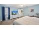 Light blue main bedroom featuring a tv and carpet flooring at 2650 60Th N Ave, St Petersburg, FL 33714