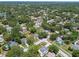 Lush community features homes with sparkling pools nestled among mature trees and winding streets, with a serene lake in the distance at 2692 Cedarbrooke Dr, Palm Harbor, FL 34684