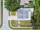 Home boasts mature trees, a well-kept lawn, and a spacious driveway, located on a tree-lined street at 2692 Cedarbrooke Dr, Palm Harbor, FL 34684