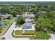 Aerial shot of the house in a peaceful neighborhood near a lake and surrounded by lush trees at 2692 Cedarbrooke Dr, Palm Harbor, FL 34684