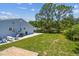 Lush backyard with a well-kept lawn and a concrete patio, creating an inviting outdoor haven at 2692 Cedarbrooke Dr, Palm Harbor, FL 34684